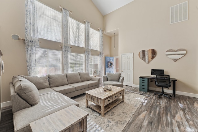 living room with high vaulted ceiling and dark hardwood / wood-style floors