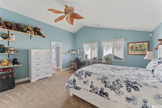 carpeted bedroom with ceiling fan, lofted ceiling, and ensuite bath