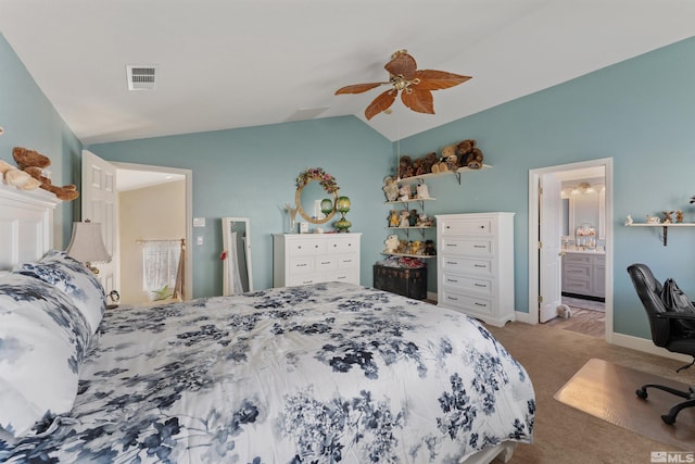 bedroom featuring ceiling fan, connected bathroom, light carpet, and lofted ceiling