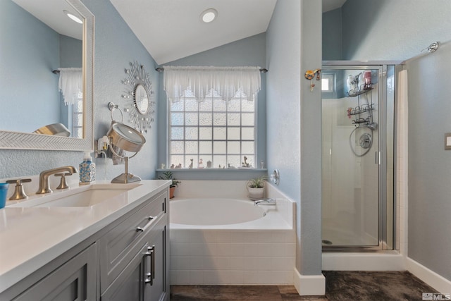 bathroom featuring vanity, lofted ceiling, and independent shower and bath