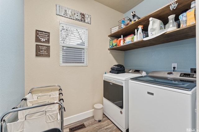 laundry room with separate washer and dryer and light wood-type flooring