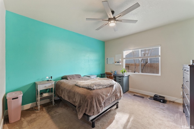 bedroom featuring light carpet and ceiling fan