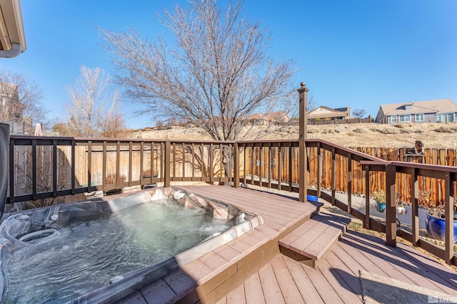 deck with an outdoor hot tub