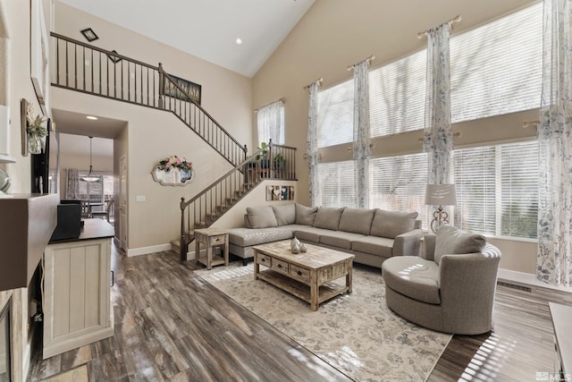 living room featuring high vaulted ceiling and wood-type flooring