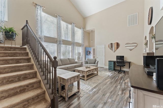 living room featuring hardwood / wood-style floors and high vaulted ceiling