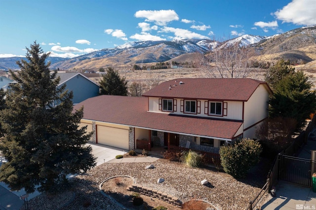 front facade featuring a mountain view and a garage