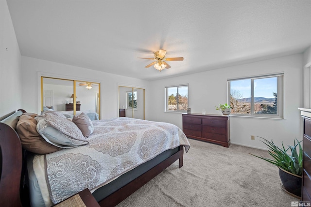 bedroom with ceiling fan, a closet, and light carpet