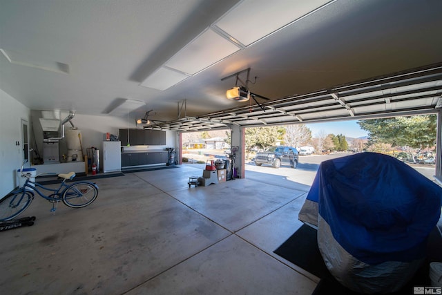 garage featuring a garage door opener and gas water heater