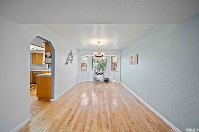 interior space featuring a chandelier and light hardwood / wood-style flooring