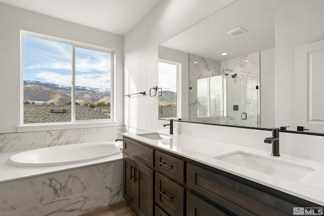 bathroom with vanity, a mountain view, and plus walk in shower