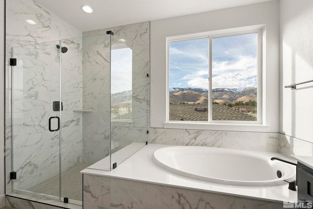 bathroom with shower with separate bathtub and a mountain view