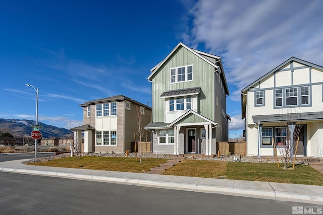 view of front facade with a mountain view and a front yard