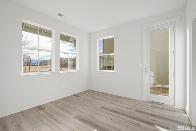 unfurnished room with light wood-type flooring