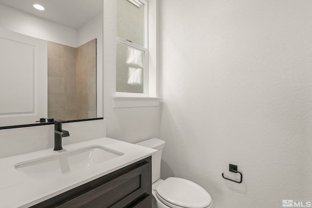 bathroom featuring toilet and vanity