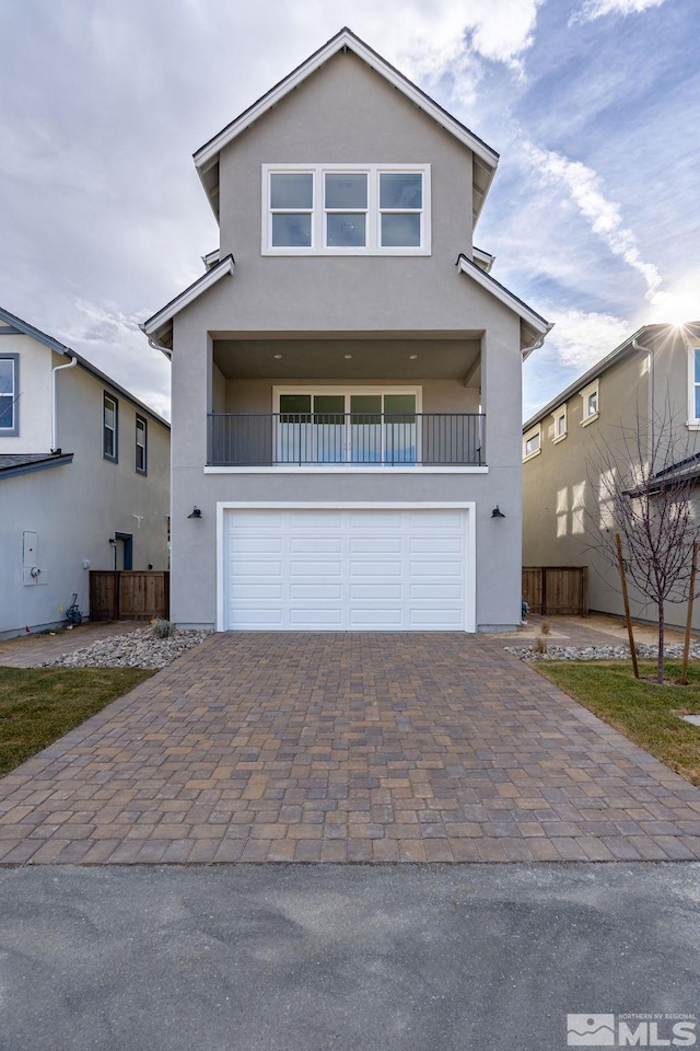 view of front of home with a balcony and a garage