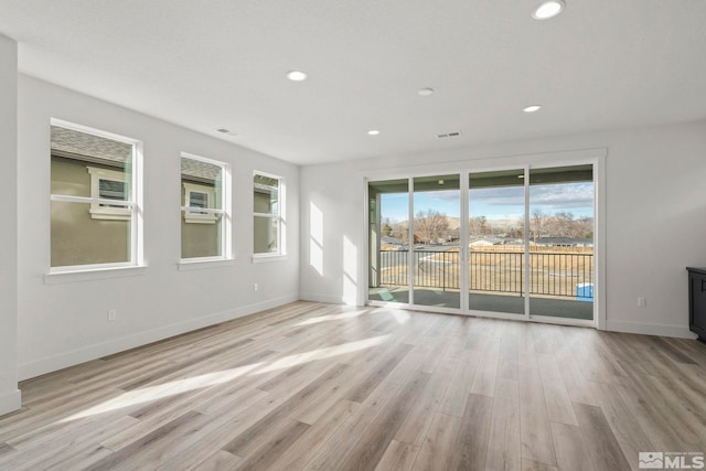 unfurnished room with light hardwood / wood-style flooring