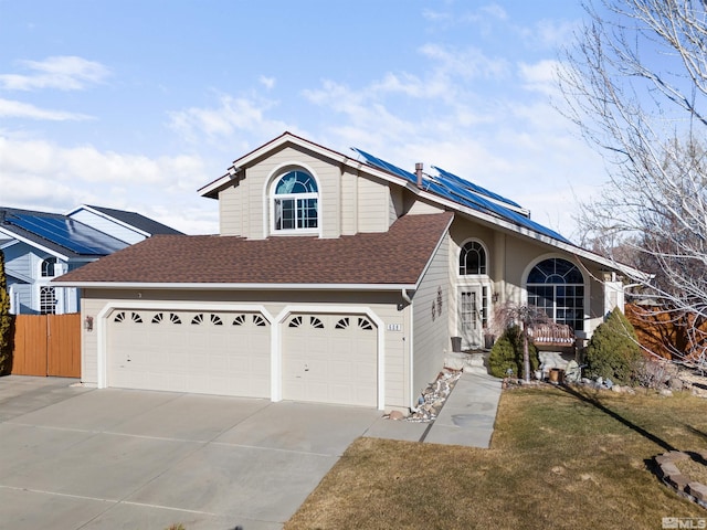 view of front of house with a front yard and a garage