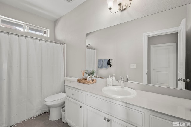 bathroom with toilet, tile patterned floors, and vanity