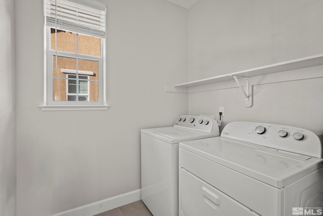 laundry area featuring separate washer and dryer and light tile patterned floors