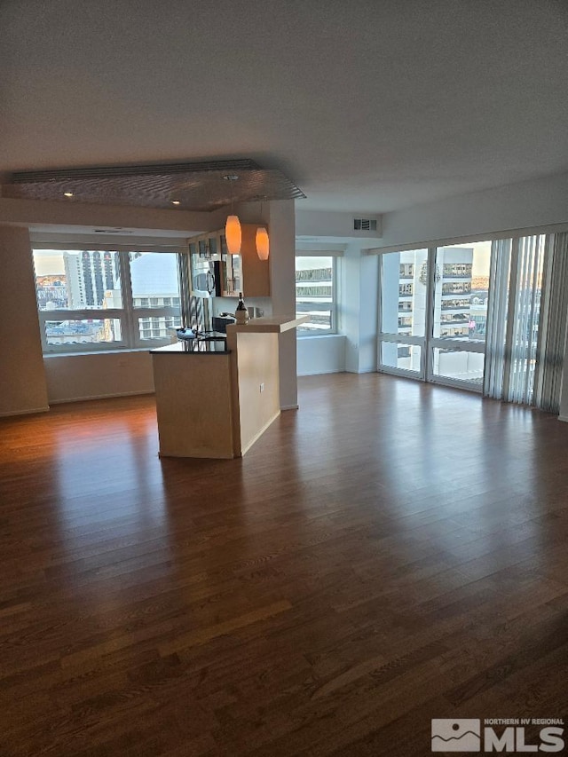 unfurnished living room featuring dark hardwood / wood-style flooring