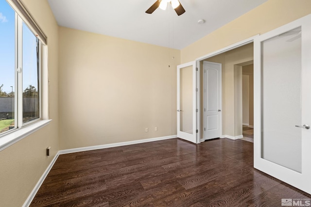 unfurnished room with ceiling fan, dark hardwood / wood-style flooring, and plenty of natural light