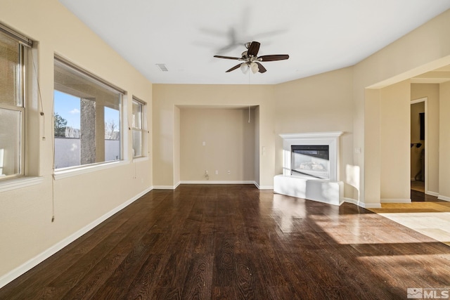 unfurnished living room featuring ceiling fan and hardwood / wood-style floors