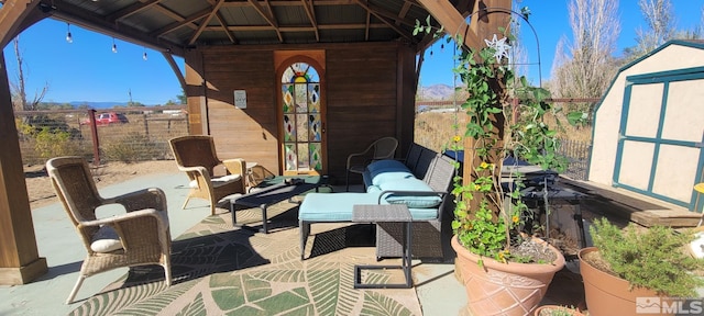 view of patio / terrace featuring a gazebo, an outdoor hangout area, and a storage shed