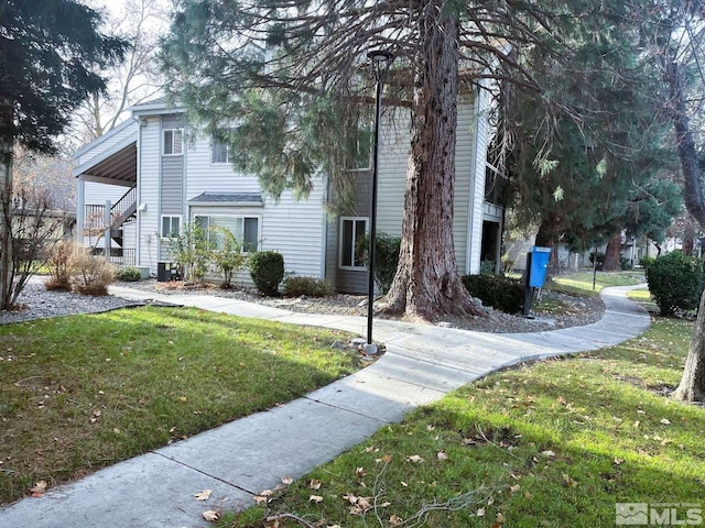 view of property exterior with a yard