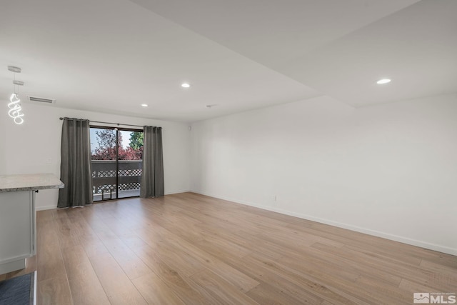 spare room with light hardwood / wood-style floors