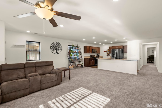 living room with ceiling fan and light carpet