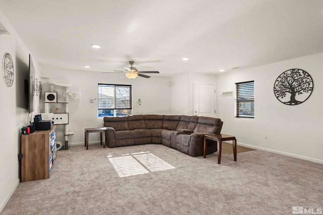 carpeted living room with ceiling fan