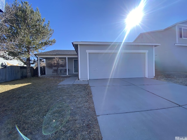 single story home featuring a porch and a garage