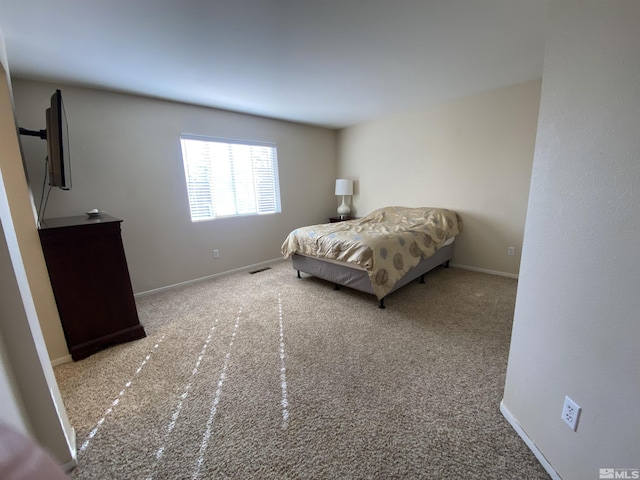 bedroom featuring light carpet