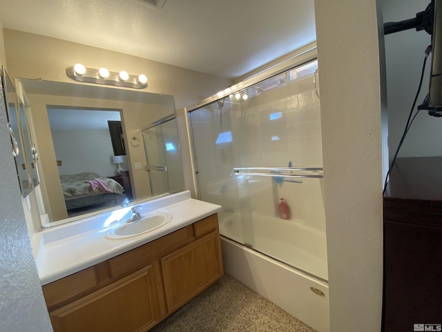 bathroom with vanity and shower / bath combination with glass door