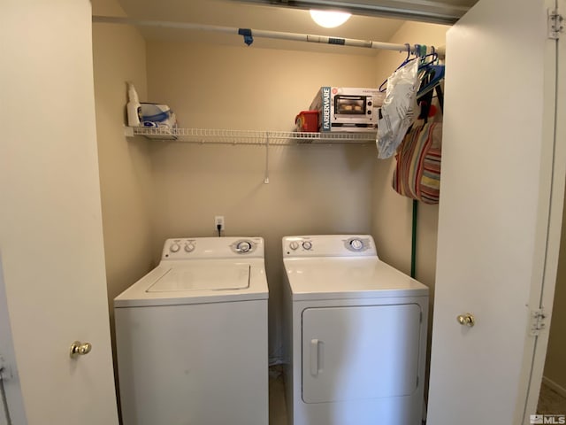 clothes washing area featuring washer and dryer