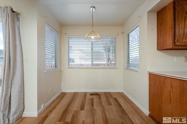 unfurnished dining area featuring light hardwood / wood-style flooring