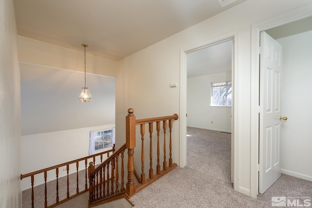 hallway featuring light carpet