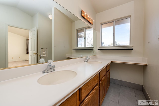 bathroom with tile patterned flooring, lofted ceiling, and vanity