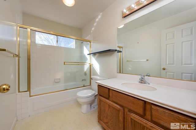 full bathroom with combined bath / shower with glass door, vanity, and toilet