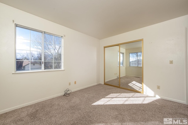 unfurnished bedroom featuring a closet and carpet