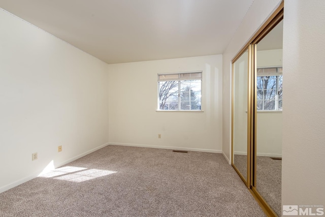 unfurnished bedroom with carpet and a closet