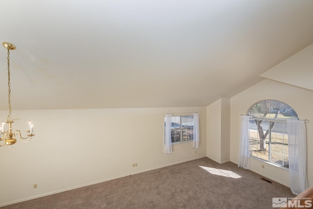 additional living space featuring vaulted ceiling, carpet floors, and a notable chandelier