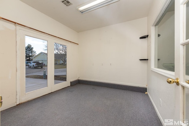 empty room featuring carpet and french doors