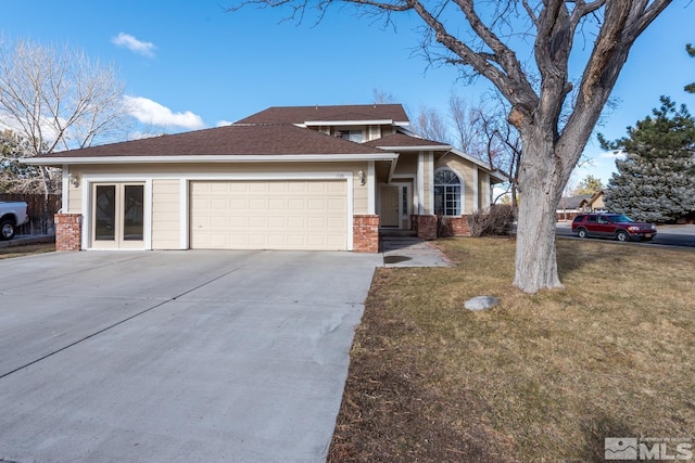 view of front of property with a garage and a front lawn