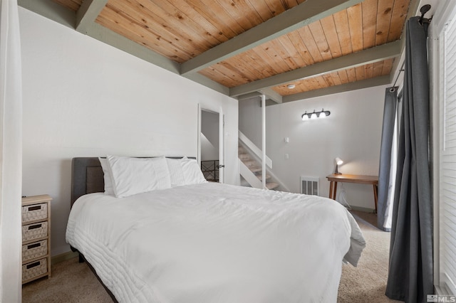 carpeted bedroom featuring wood ceiling and beamed ceiling