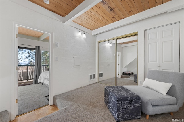 sitting room with wooden ceiling, beamed ceiling, and parquet flooring