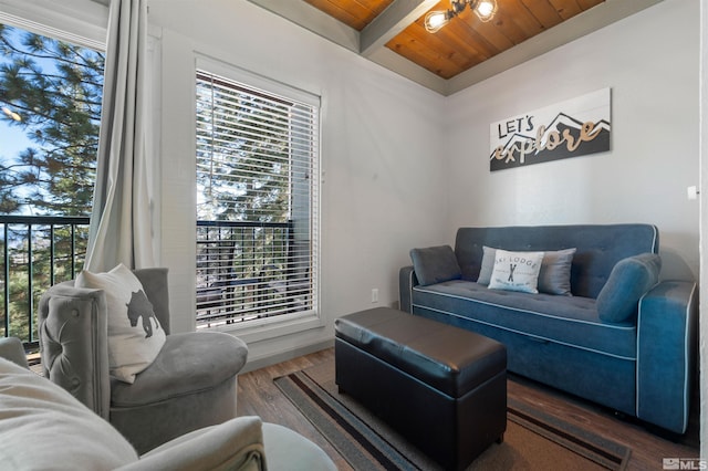 living room with dark wood-type flooring, wood ceiling, and beam ceiling