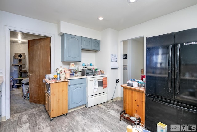 kitchen with white electric stove, black fridge, and light wood-type flooring