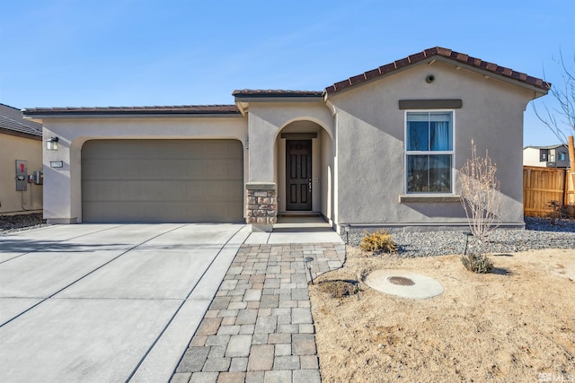 mediterranean / spanish-style house with driveway, a garage, a tile roof, fence, and stucco siding