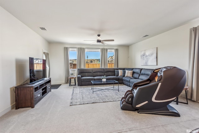 living area with a ceiling fan, visible vents, and baseboards